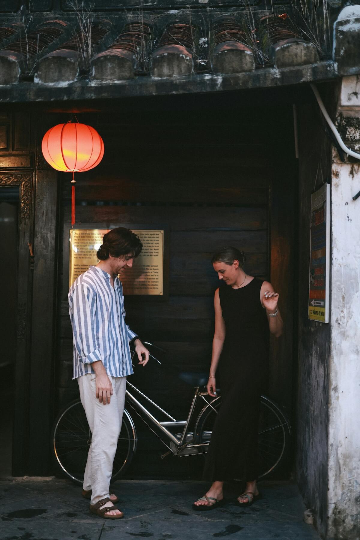 Unsplash: Man and woman talking in alley Hoi an Photographer