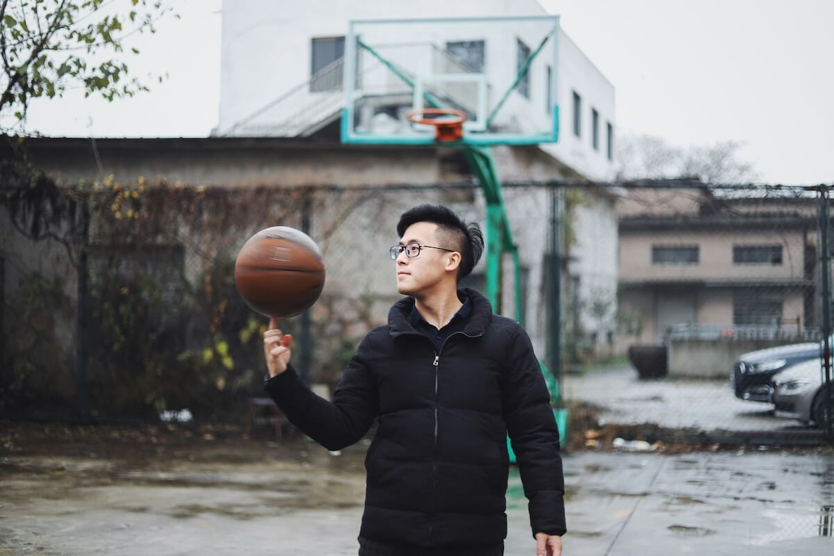 Unsplash: man balancing basketball on finger by Raychan