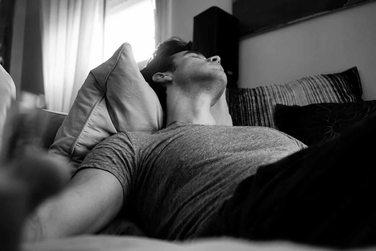 Unsplash: Man sleeping in black and white by Adi Goldstein