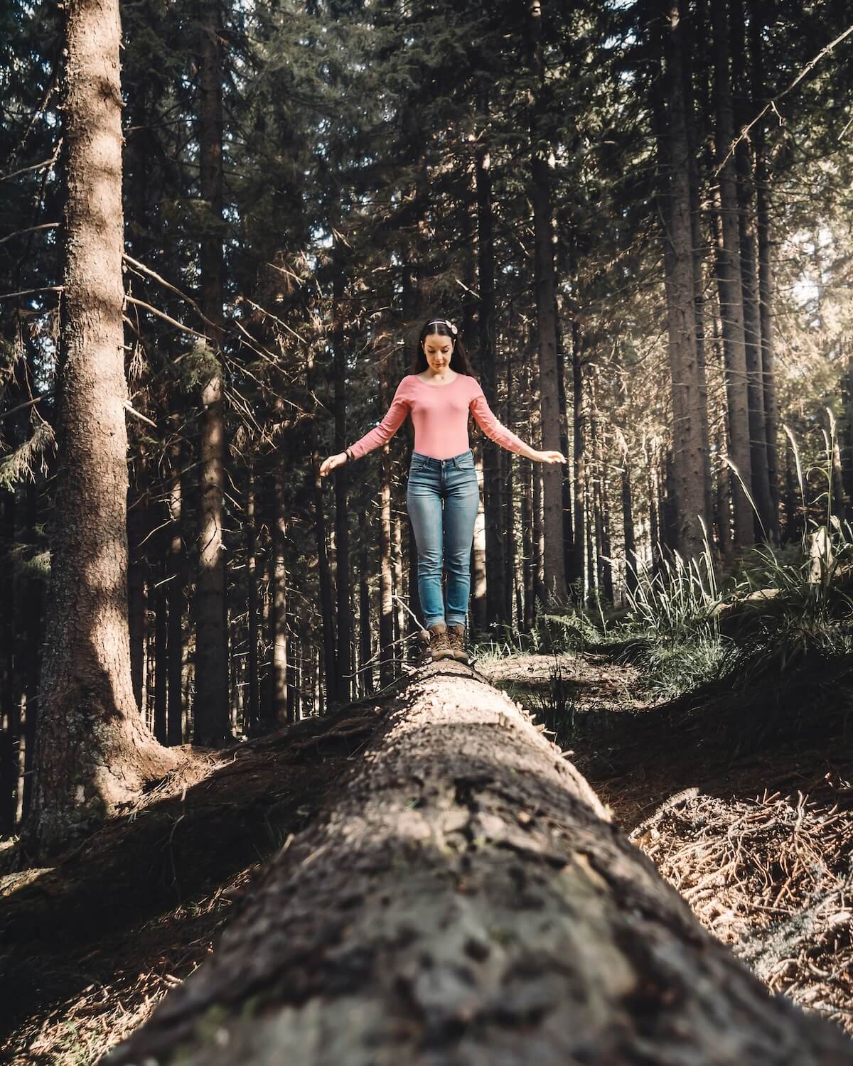 Unsplash: Woman walking on log and balancing by inspa makers