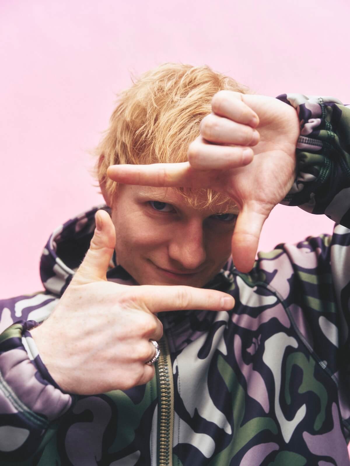 Ed Sheeran making play button with hands