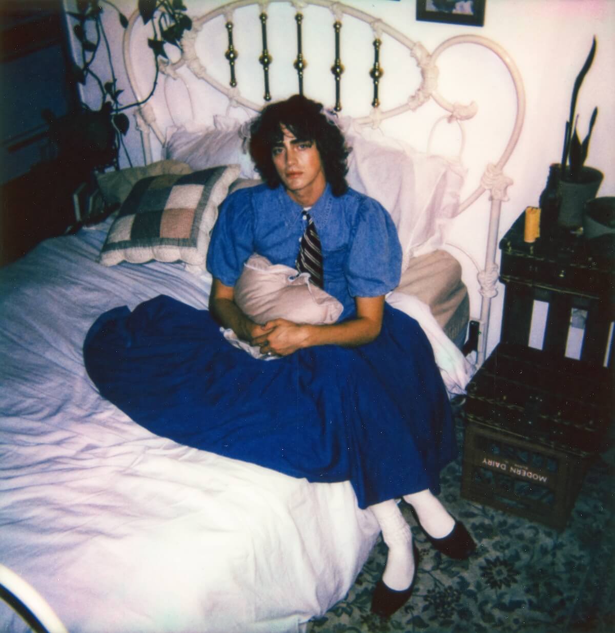 Fin Argus blue shirt and skirt on bed for Playboy 1973