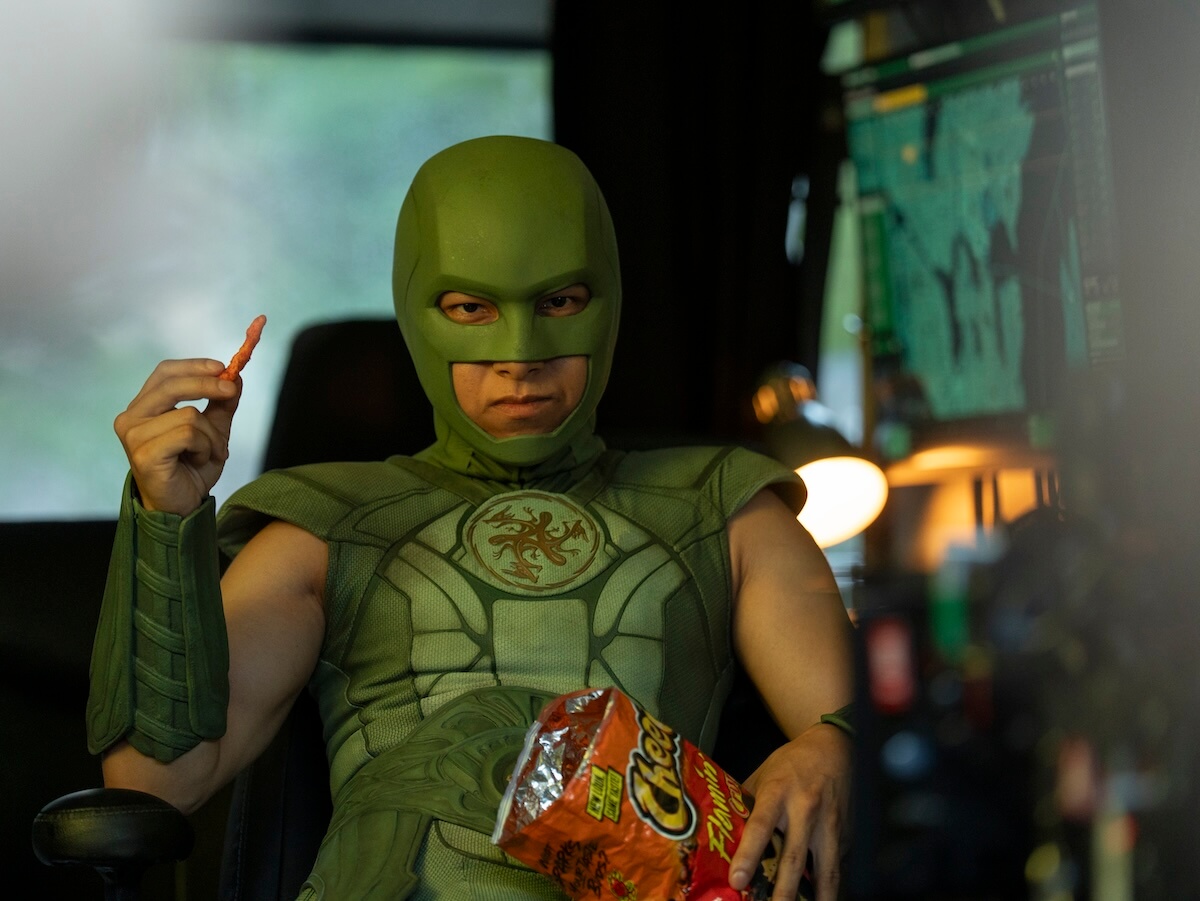 Nhut Le in Peacemaker as Judomaster eating hot cheetos