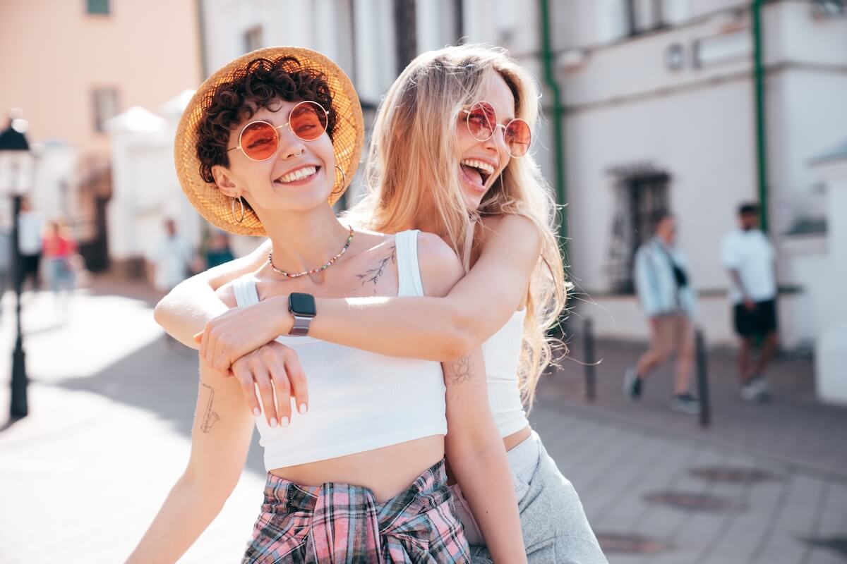 Shutterstock: Two young beautiful smiling hipster female in trendy summer white t-shirt and shorts clothes. Sexy carefree women posing in the street. Positive models having fun, hugging and going crazy