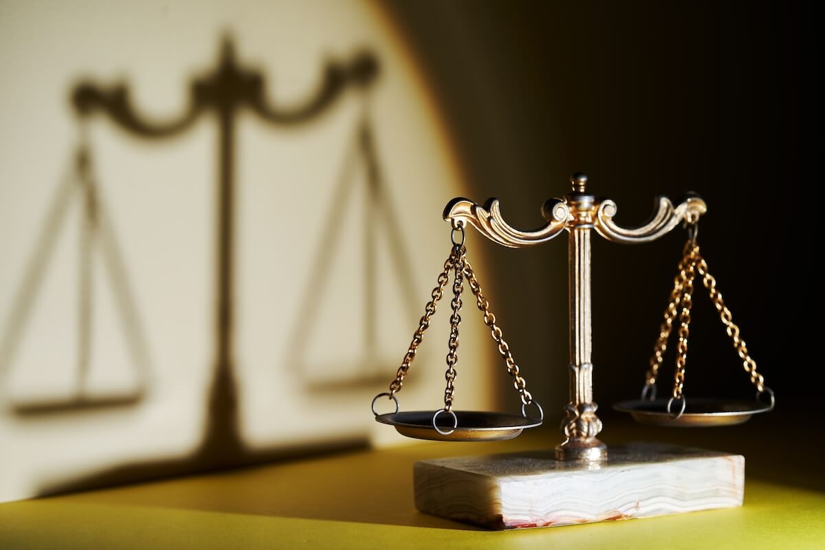 Shutterstock: vintage libra scale with shadow against yellow background