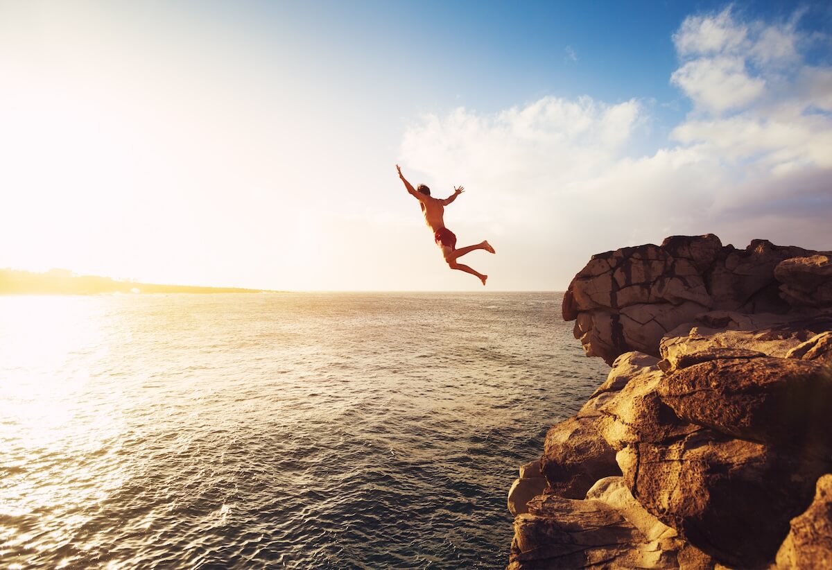 Shutterstock: Cliff Jumping into the Ocean at Sunset, Summer Fun Lifestyle