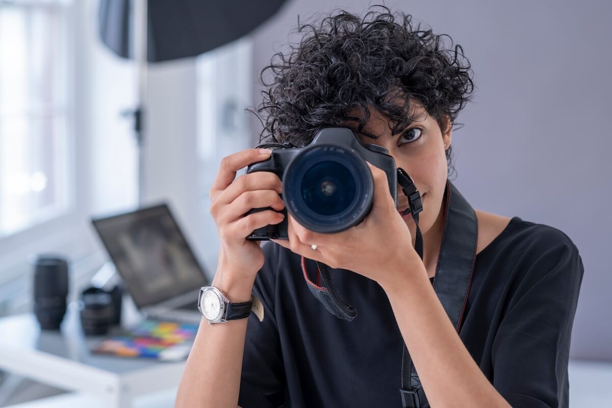 Shutterstock: Female photographer taking photos with digital camera