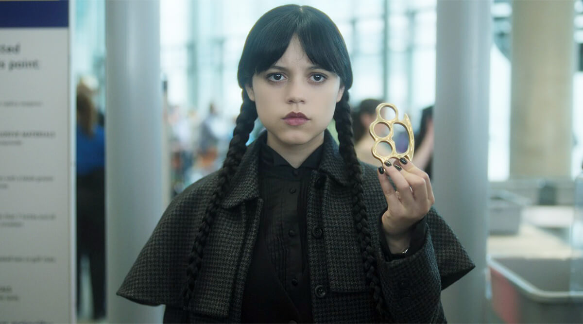 Wednesday: Wednesday Addams going through airport security with brass knuckles
