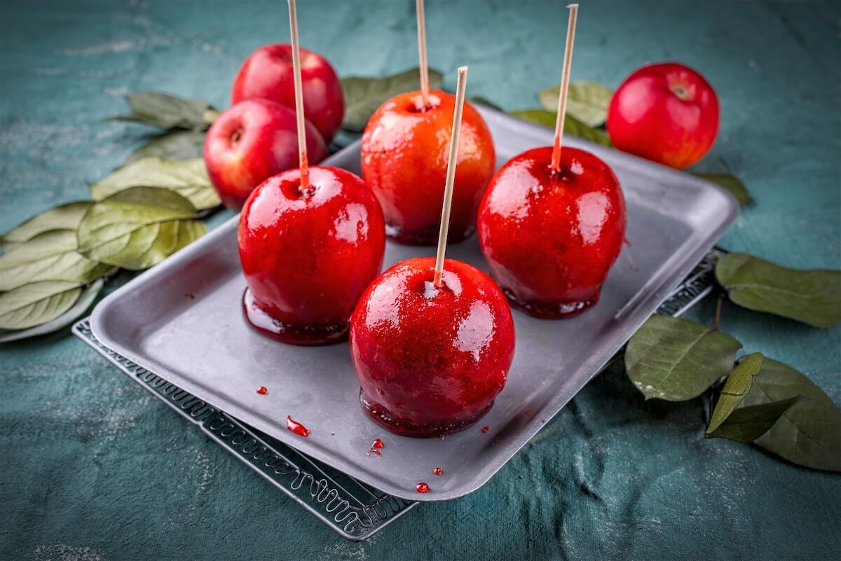 Shutterstock: Apples of love - classic candy apples with traditional red suger caramel glaze coating - festive sweet snack street food