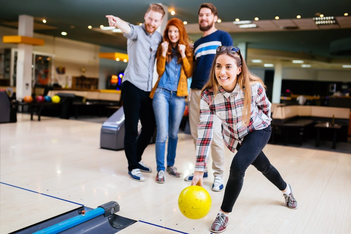 Shutterstock: Competitve people enjoying bowling