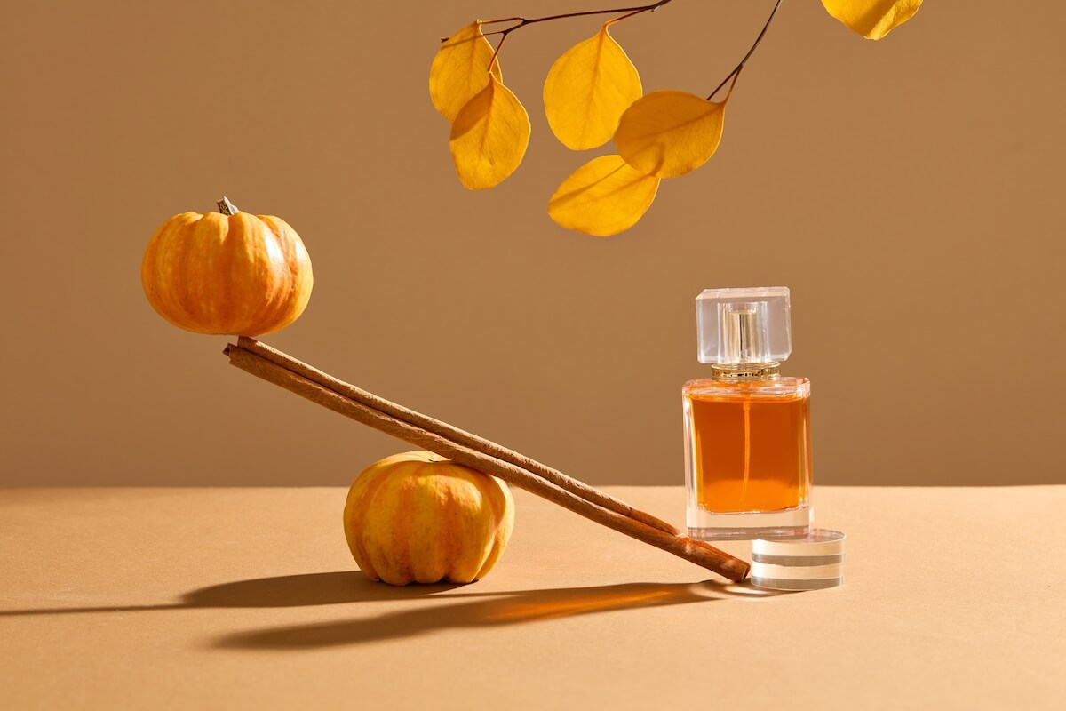Shutterstock: A cinnamon stick in the middle with a pumpkin and perfume bottle at both ends form a seesaw. Cozy autumn photography
