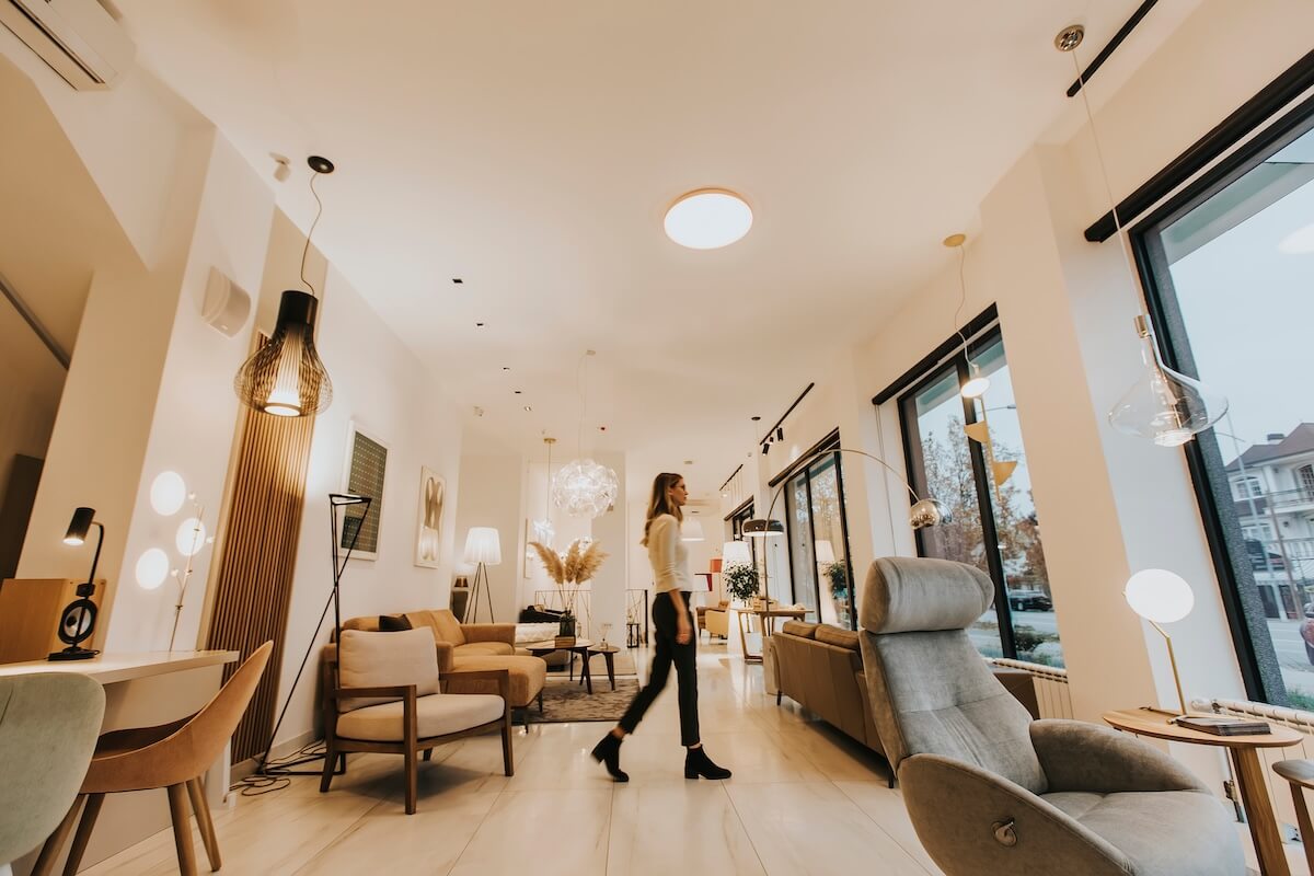 Shutterstock: Pertty young woman walking through modern livingroom