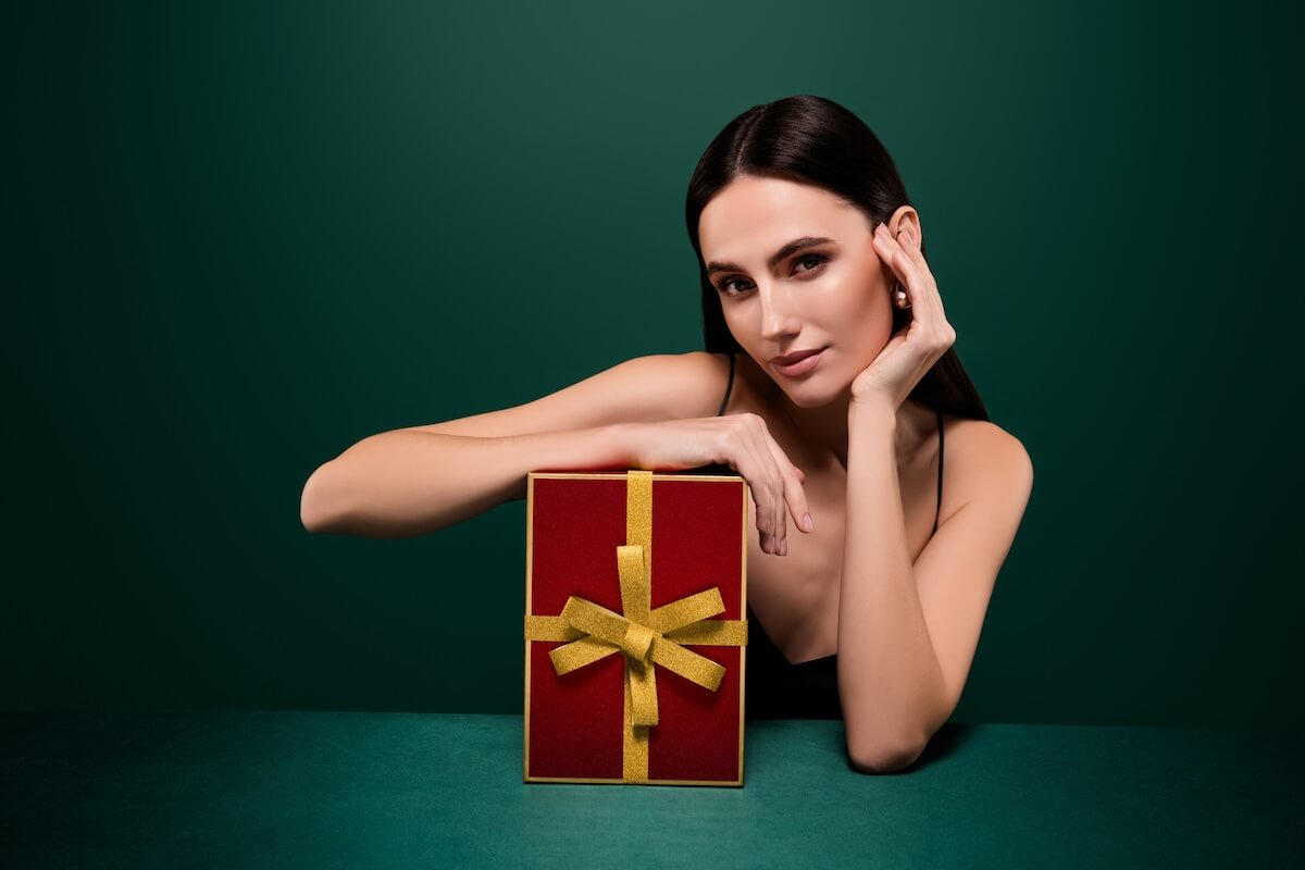 Shutterstock: Photo of stunning adorable lady dressed sexy outfit getting xmas gift isolated green color background