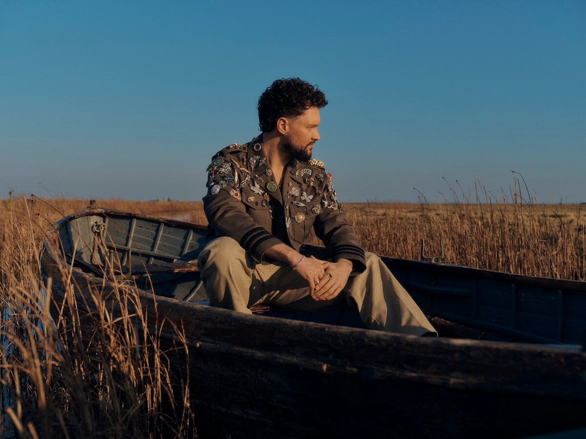 Calum Scott Avenoir press image in boat with broaches