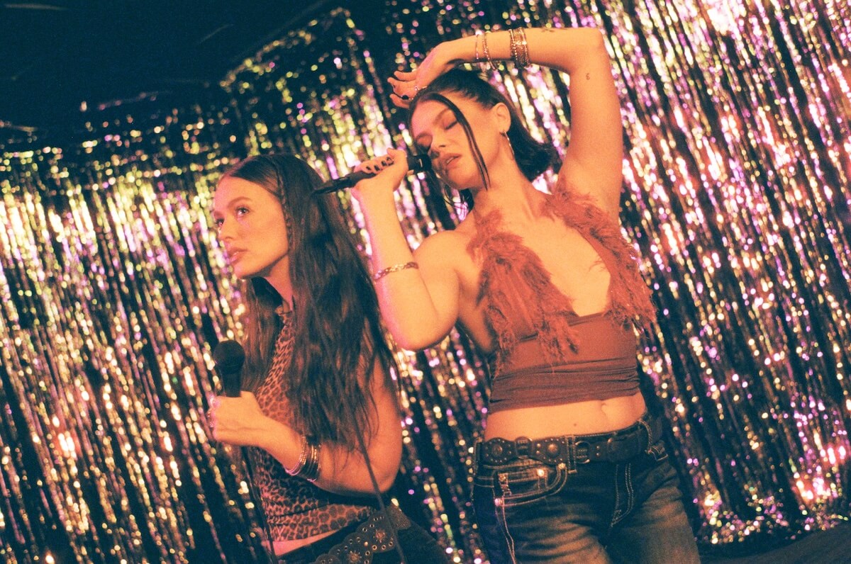 Moody Joody 'OOPS!' press image against glitter curtain