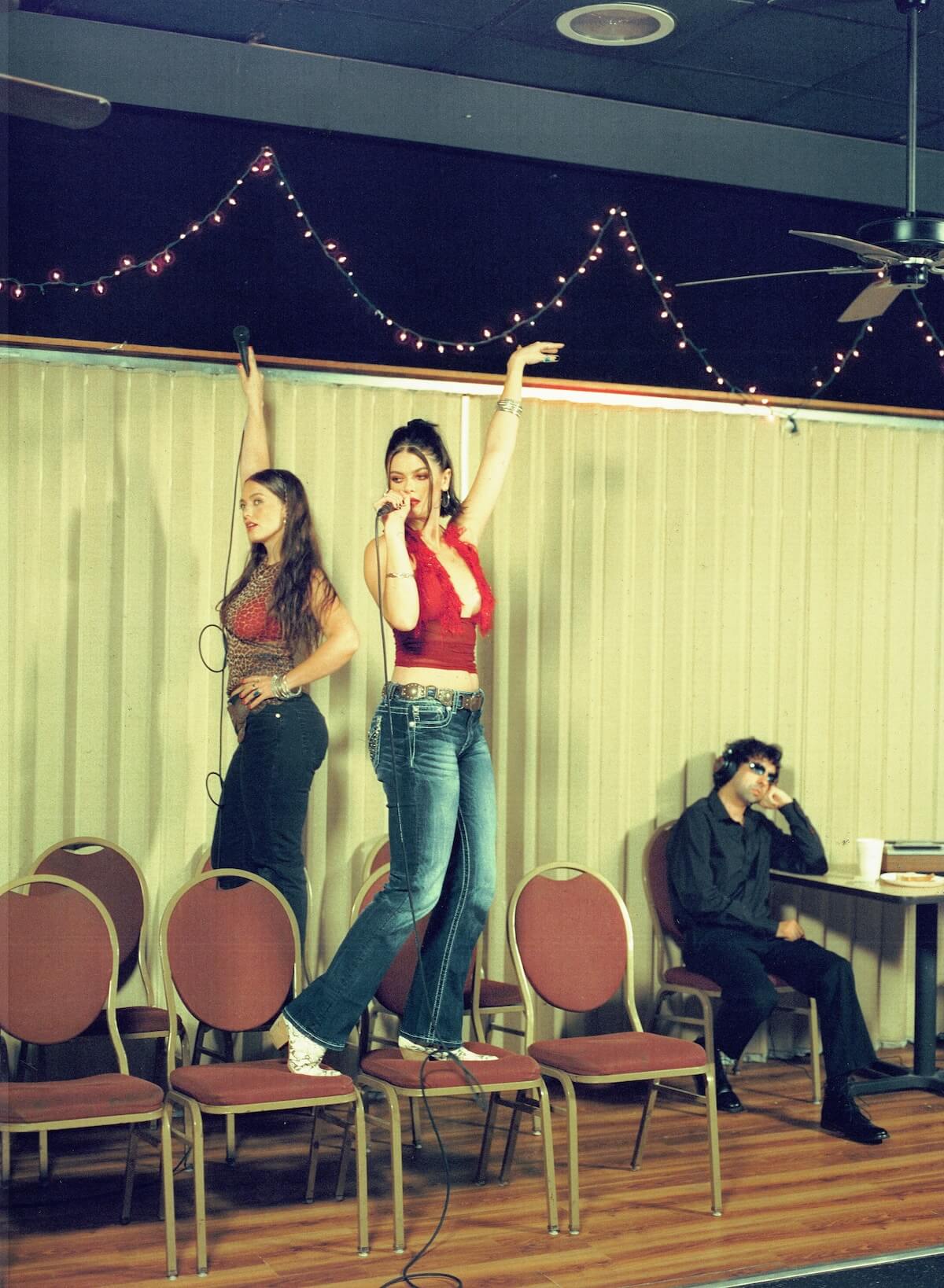 Moody Joody 'OOPS!' press image standing on chairs