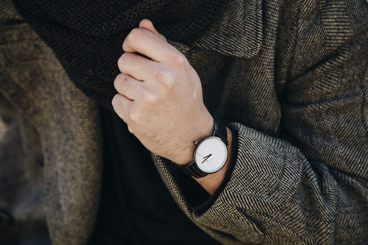 Shutterstock: Close up of man's watch in herringbone jacket