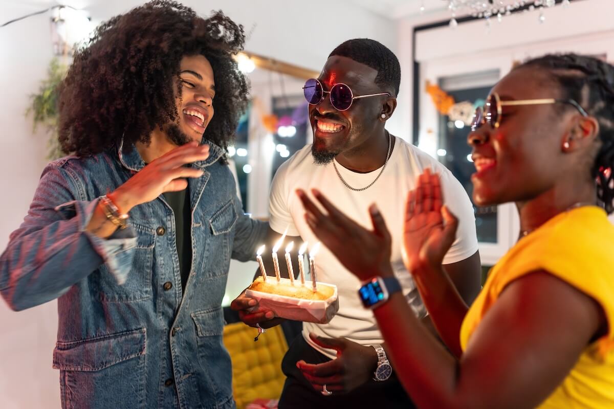Shutterstock: Friends laughing and celebrating a birthday party together